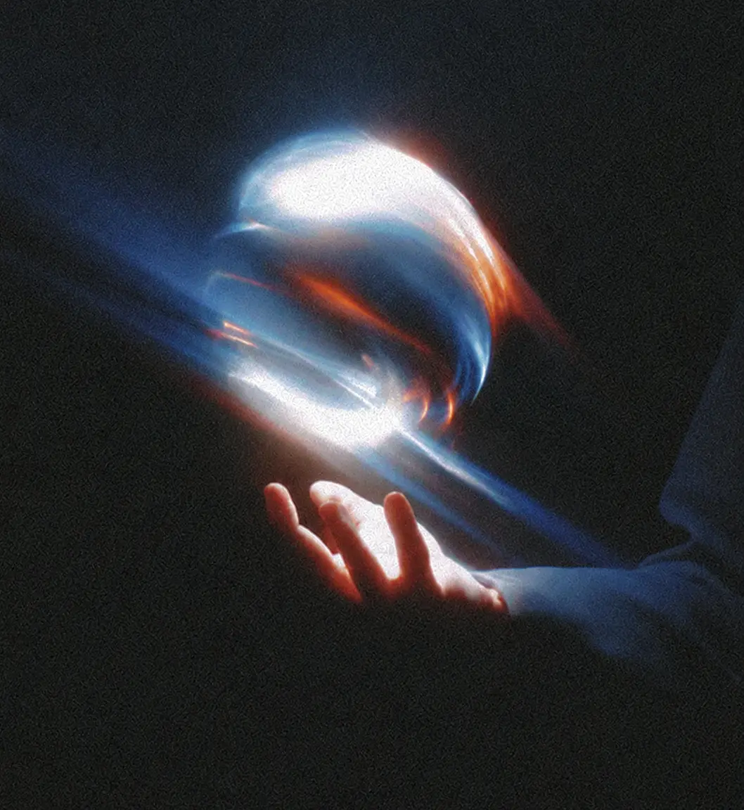 A glowing orb of light levitating above an open hand